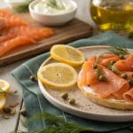 Flat lay of cold-smoked and hot-smoked salmon with garnishes