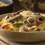 Philly cheesesteak pasta with steak, cheese, and peppers
